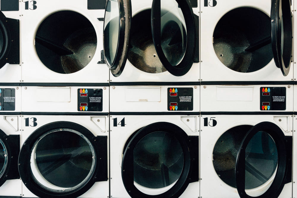 Bright aisle of washing machines in a laundromat